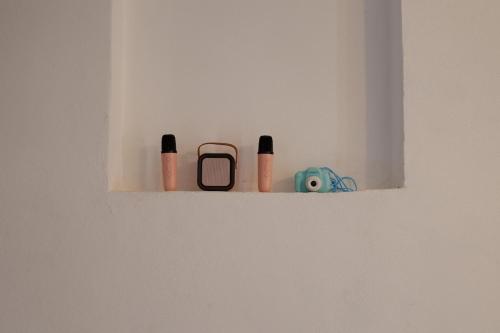 a shelf with a cell phone and other items on it at La Casina Massa in Massa