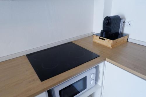 a kitchen with a counter top with a microwave at La Casina Massa in Massa
