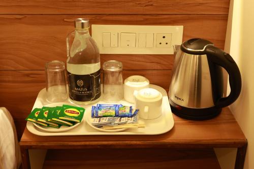 a tray with a bottle of wine on a table at Swiss Holidays in Pinangode