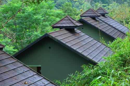 two shingles on top of a green building at Swiss Holidays in Pinangode