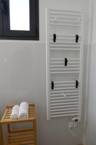 a bathroom with two towels sitting on a shelf at La Casina Massa in Massa