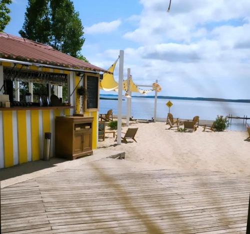 a restaurant on a beach with a view of the ocean at Hôtel Latécoère in Biscarrosse