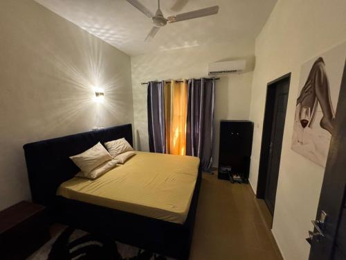 a bedroom with a bed and a window at Luxury Nest in Kika