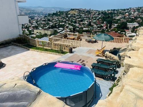 a view of a swimming pool on top of a building at Panorama Hills Apart-Hotel in Tbilisi City