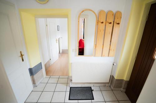 a room with a hallway with a mirror and a door at Stift Göttweigblick in Furth