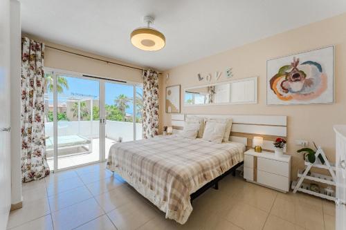 a bedroom with a bed and a large window at Ocean View Duplex Tenerife ( Golf del Sur) in San Miguel de Abona
