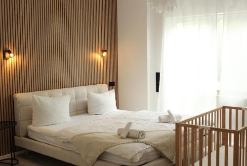a bedroom with a white bed with white pillows at DREAMSPACE Frankfurt Airport in Kelsterbach