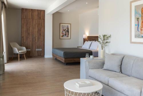 a living room with a bed and a couch at Port Tower Piraeus in Piraeus