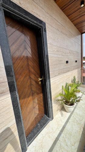 a wooden door on the side of a building at Boutique Apartments By One Tree in Jodhpur