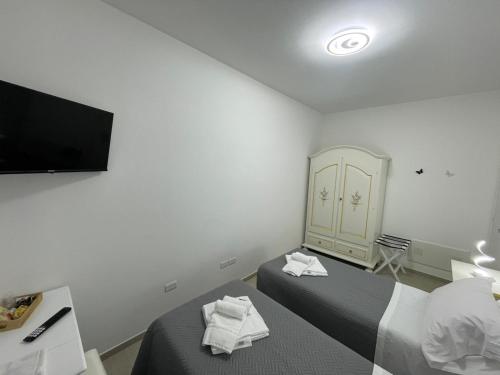 a hotel room with two beds and a television at CASA NINA affittacamere 2 in Camerino