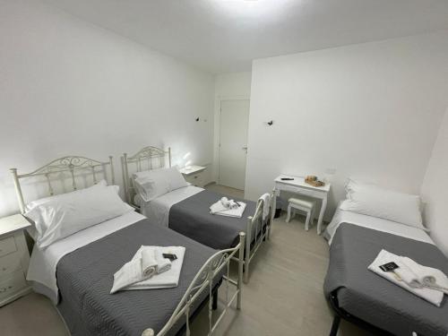 a room with two beds with towels on them at CASA NINA affittacamere 2 in Camerino