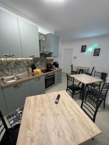 a kitchen with a wooden table and two tables and chairs at CASA NINA affittacamere 2 in Camerino