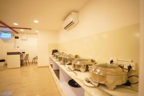 a row of pots on a counter in a kitchen at Z Bliss Suites, BKC in Mumbai