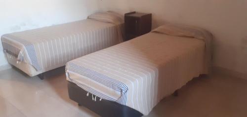 two beds sitting next to each other in a room at María del Valle Alojamientos in Belén