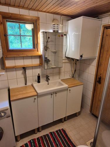 a small kitchen with a sink and a window at Kutala Cottage in Kutala