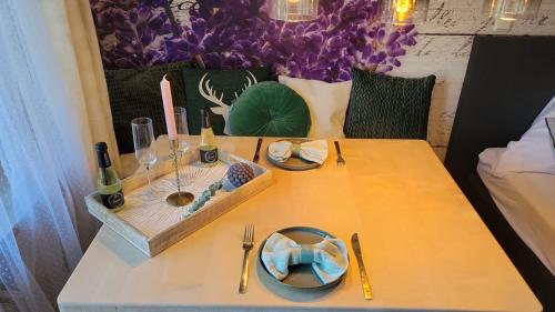 a table with two plates of food and wine on it at Ferienwohnung Lavendel in Oberstdorf