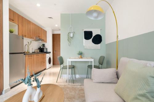 a living room with a couch and a table at Masdar Tranquil Studio near F1 Circuit & Airport in Abu Dhabi