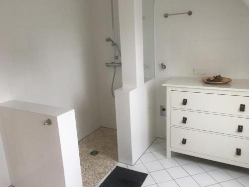 a bathroom with a white cabinet and a dresser at Ferienglück Lindwedel in Lindwedel