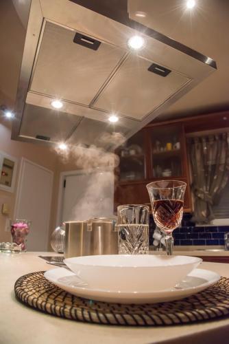 a plate and a glass of wine on a counter at Alexander Seaside in Preveza