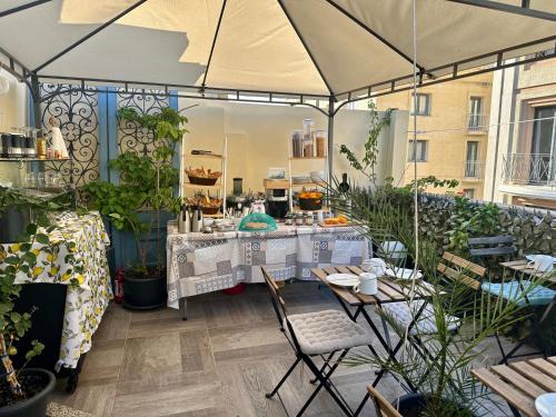a patio with a table and chairs and a tent at Backstage Boutique Music Themed Townhouse in Sliema