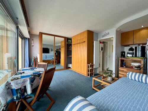 a bedroom with a bed and a dining room with a kitchen at Ocean View 2 in Lacanau