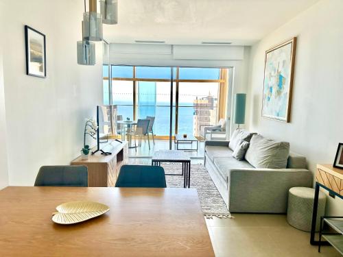 a living room with a couch and a table at Intempo by Holuxe - 176 - 17th floor in Benidorm