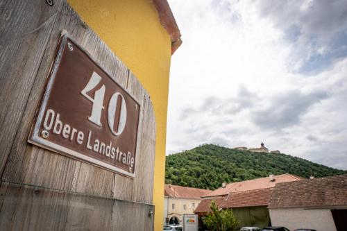 a sign on a building with a mountain in the background at Stift Göttweigblick in Furth