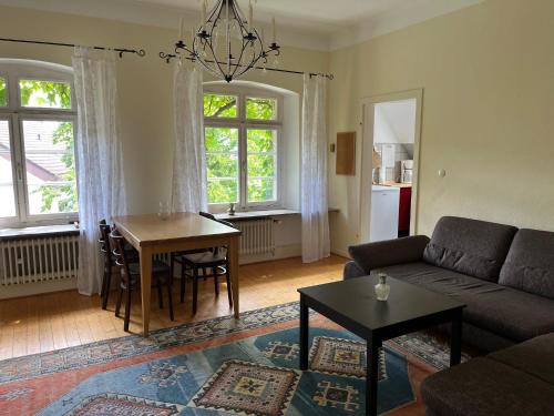 a living room with a couch and a table at Haus Kroneck-Salis Ferienwohnung in Bad Iburg