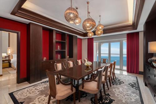 a dining room with a table and chairs at Rixos Marina Abu Dhabi in Abu Dhabi