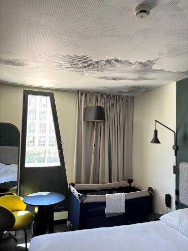 a hotel room with a bed and a window at ibis Marseille Centre Euromed in Marseille