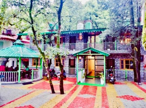 a group of houses with a playground in the street at The Boho Woods Resort in Nainital
