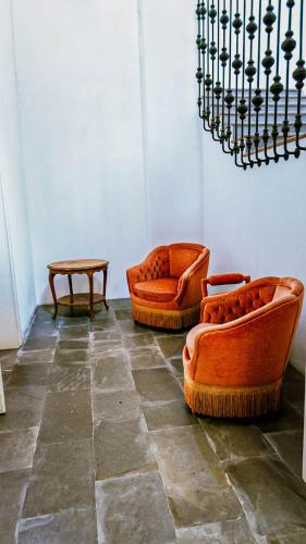 two orange chairs and a table in a room at Villa Trigatti Michieli 