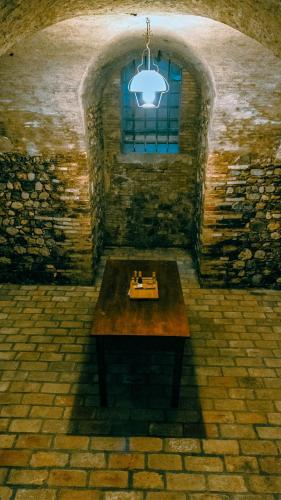 a room with a table in a stone building with a window at Villa Trigatti Michieli 