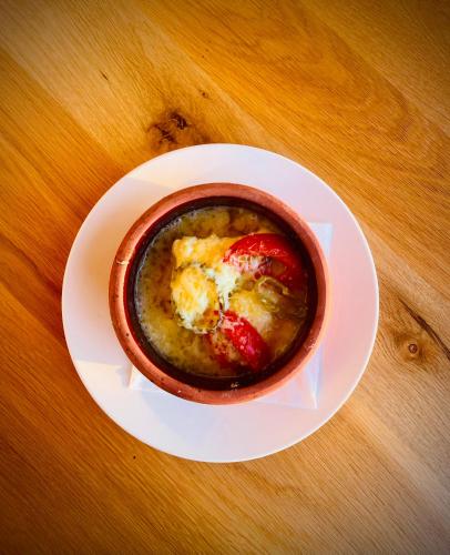 a cup of soup on a plate on a table at Valza Boutique Hotel in Vlorë
