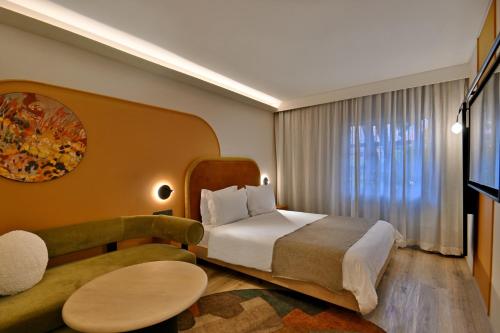 a hotel room with a bed and a couch at City Lodge Hotel V&A Waterfront in Cape Town