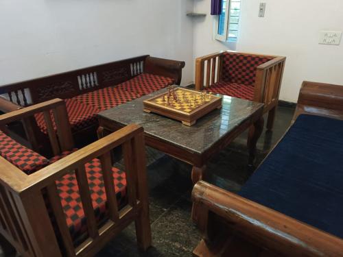 a table with a chess board on top of it at Art Le Cafe in Auroville