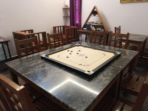 a table with a clock on top of it at Art Le Cafe in Auroville