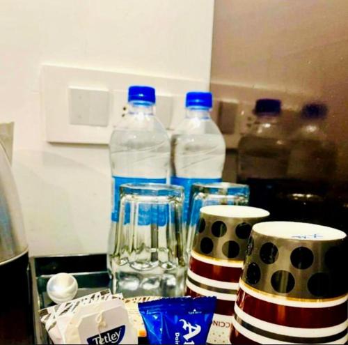 a group of bottles of water sitting on a kitchen counter at The Boho Woods Resort in Nainital