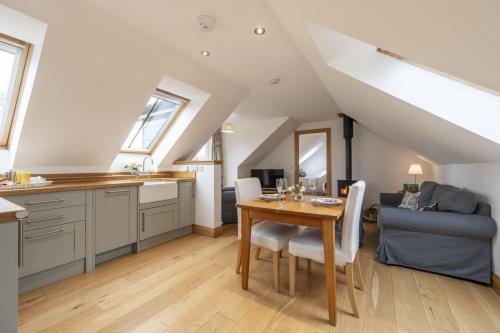 a kitchen and dining room with a table and a couch at The Keep in Kirknewton