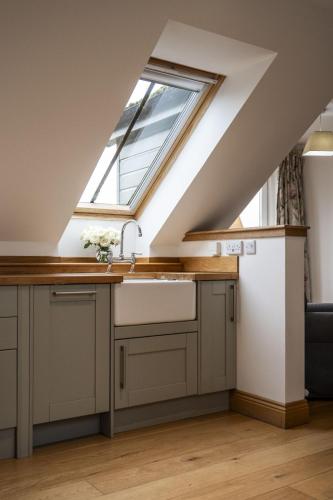 a kitchen with a sink and a window at The Keep in Kirknewton