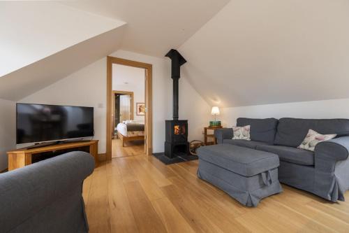 a living room with a couch and a fireplace at The Keep in Kirknewton
