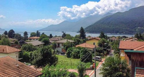 a village with a view of a lake and mountains at Casa Robilio in Maccagno con Pino e Veddasca
