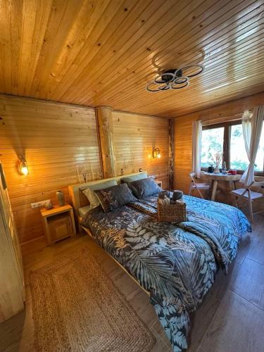 a bedroom with a bed in a wooden room at EtnoLux Apartmani in Živinice