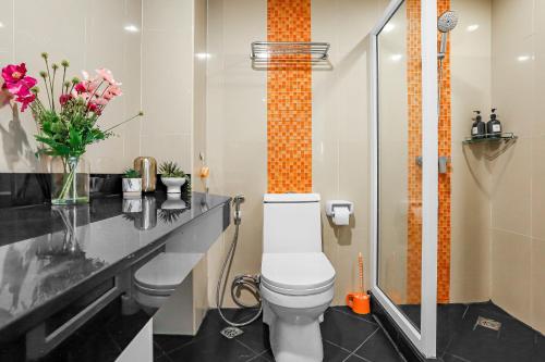 a bathroom with a toilet and a black counter at Luxurious Penthouse Pattaya in Pattaya South