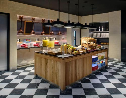 a kitchen with a counter with food on it at citizenM Dublin St Patrick's in Dublin