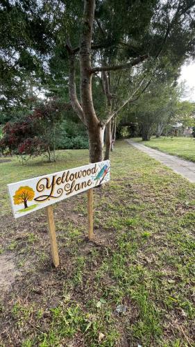 a sign in the grass in front of a tree at Armadale Country Retreat in Gqeberha