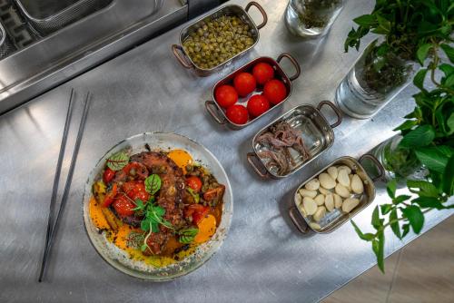a table with a plate of food and bowls of food at Paradiso Dreams Hotel in Nesebar