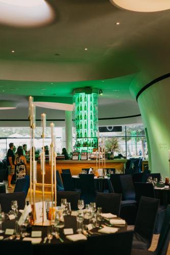 a restaurant with tables and chairs and a green ceiling at DoubleTree by Hilton Wroclaw in Wrocław
