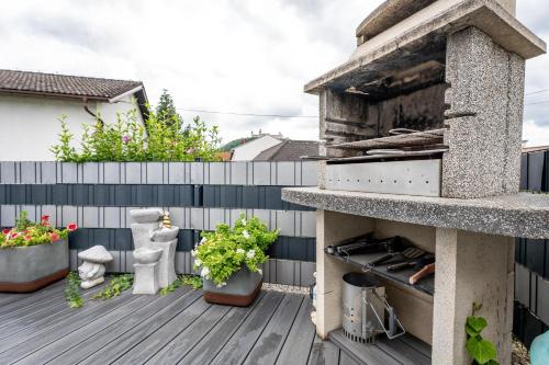 a patio with a pizza oven on a deck at Idyllisches, barrierefreies Ferienhaus in Furth