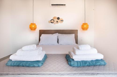 a room with a bed with two pillows at Mediterranean Blue Suites & Villa - Blue Bay Suite in Tympáki